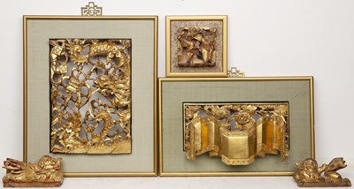 Lot 516 - Group of carved wood and gilt-painted temple...