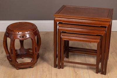 Lot 276 - A Chinese hardwood nest of three tables together with a circular drum table