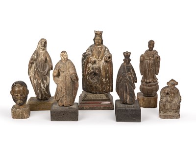 Lot 194 - A group of seven antique carved wood Santos...