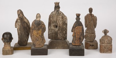 Lot 194 - A group of seven antique carved wood Santos...
