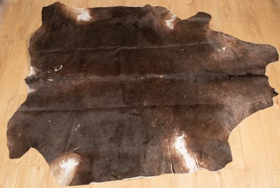 Lot 247 - A cow hide rug