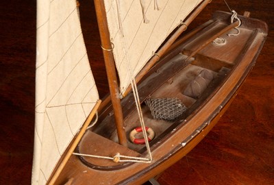 Lot 143 - A wooden model yacht
