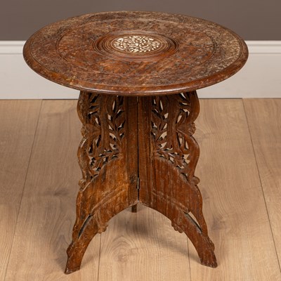 Lot 307 - An Indian hardwood foldout occasional table