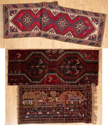 Lot 411 - A Turkish Dosemealti runner; together with a further tribal runner; and a modern tribal carpet