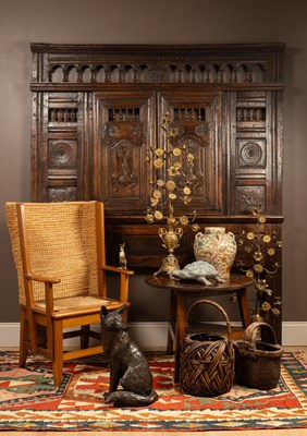 Lot 1126 - A 17th century carved oak paneled headboard