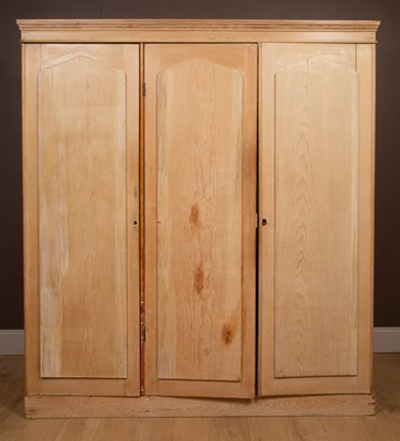 Lot 339 - A Victorian stripped pine triple wardrobe