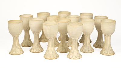 Lot 1093 - A set of fourteen pottery wine goblets