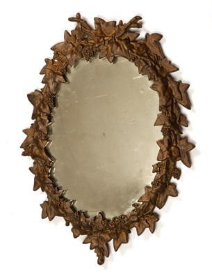 Lot 517 - An oval cast iron framed mirror