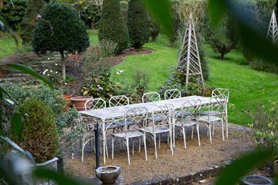 Lot 1301 - A set of white-painted cast aluminum garden furniture