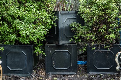 Lot 1237 - A set of four square section faux lead garden planters