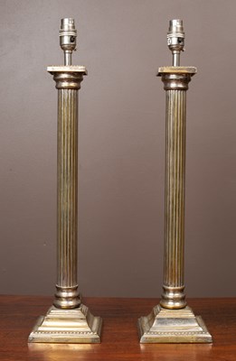 Lot 402 - A pair of silver plated brass standard lamps styled as Doric columns