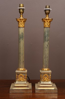 Lot 418 - A pair of gilt metal and brass table lamps...