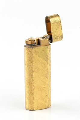 Lot 613 - A gold plated lighter by Cartier, of rounded...