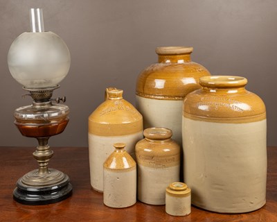 Lot 508 - A group of stoneware jars and an old oil lamp