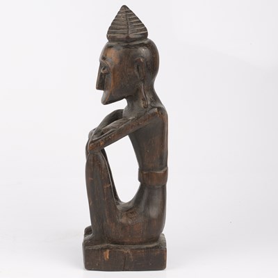 Lot 348 - An antique carved wood tribal seated figure...