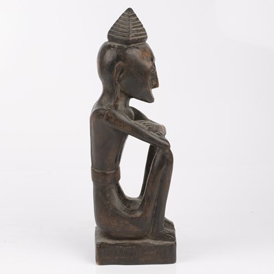 Lot 348 - An antique carved wood tribal seated figure...