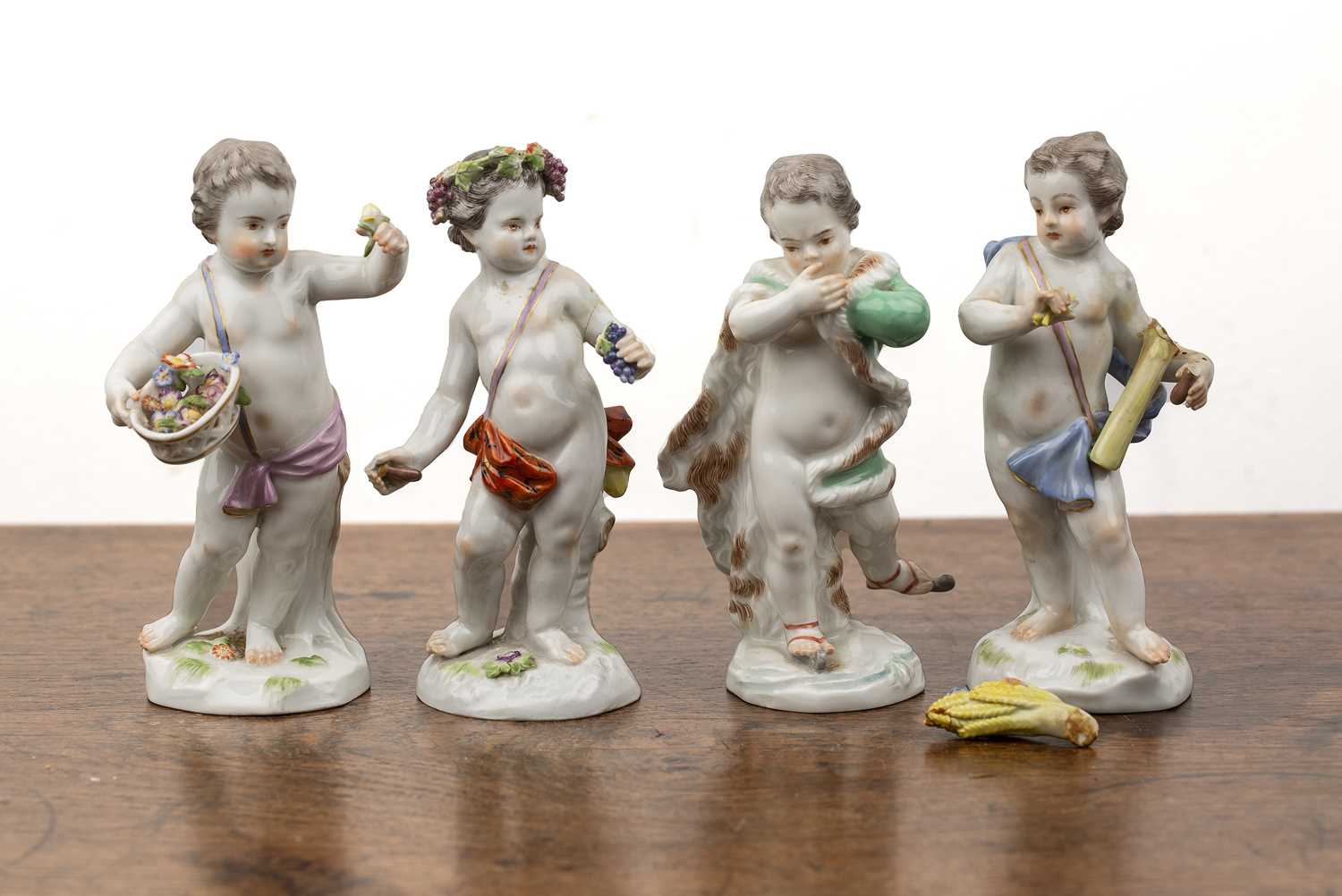 Lot 261 - Set of four Meissen putti figures as...