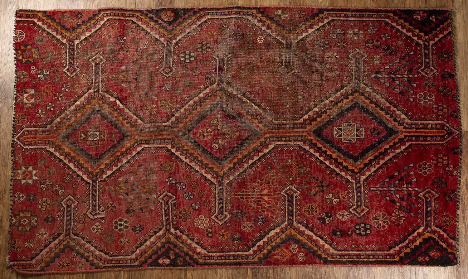 Lot 44 - Red ground rug fragment of geometric design,...