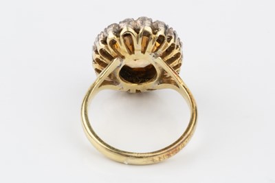 Lot 9 - A topaz and diamond cluster ring, the oval...