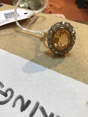 Lot 9 - A topaz and diamond cluster ring, the oval...