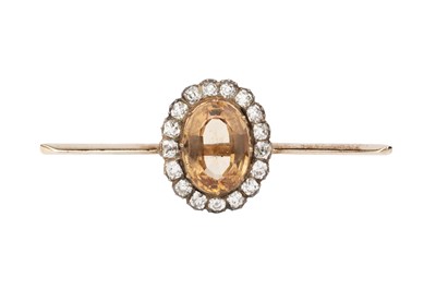 Lot 10 - A topaz and diamond mounted bar brooch, the...