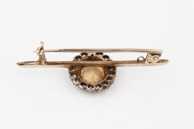 Lot 10 - A topaz and diamond mounted bar brooch, the...