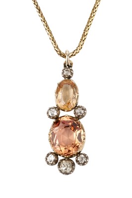 Lot 11 - A topaz and diamond pendant, formed from oval...