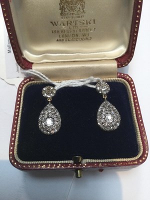 Lot 16 - A pair of diamond ear pendants, each designed...