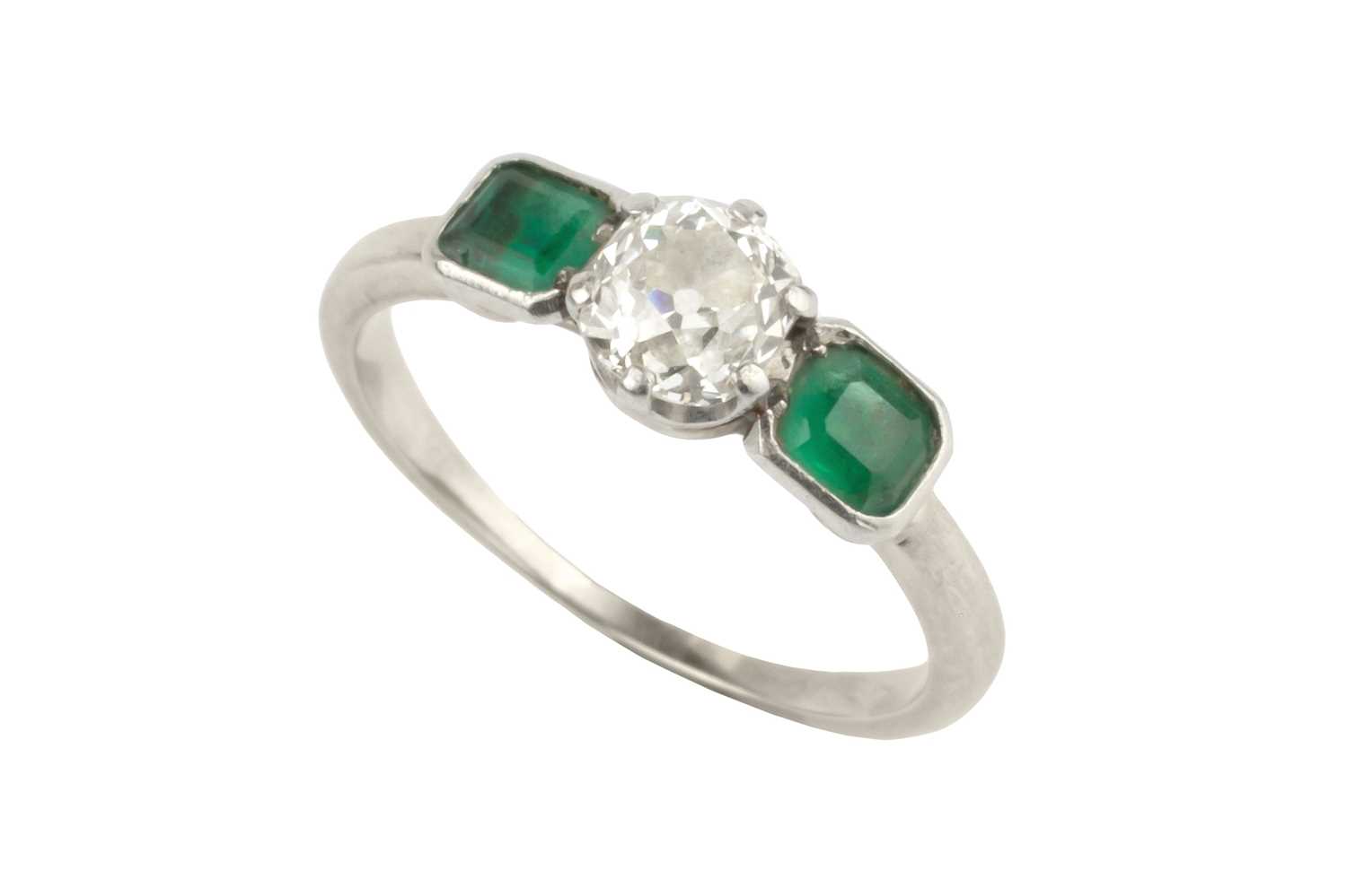 Lot 24 - A diamond and emerald three stone ring, the...