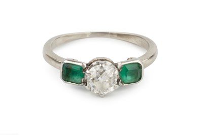 Lot 24 - A diamond and emerald three stone ring, the...