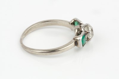 Lot 24 - A diamond and emerald three stone ring, the...