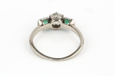 Lot 24 - A diamond and emerald three stone ring, the...