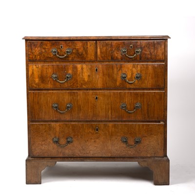 Lot 31 - A George II walnut chest of two short and...