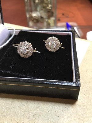 Lot 100 - A pair of diamond cluster earrings, the...