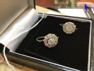 Lot 100 - A pair of diamond cluster earrings, the...
