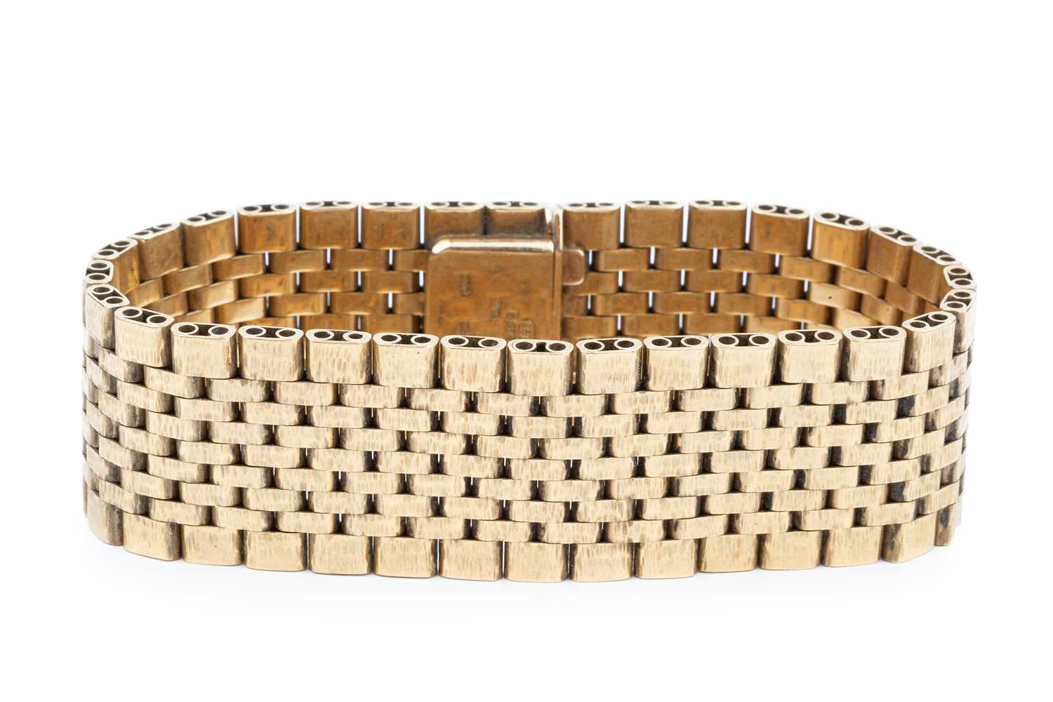 Lot 104 - A 9ct gold flexible link strap bracelet, with...