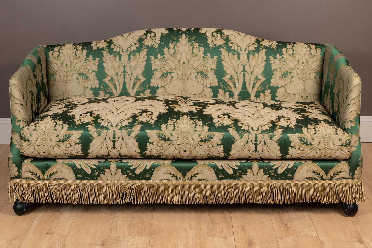 Lot 140 - A camel back sofa