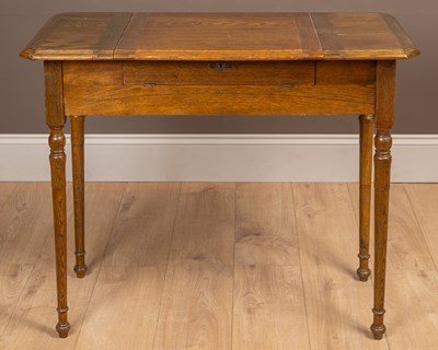 Lot 124 - An oak fold-out desk