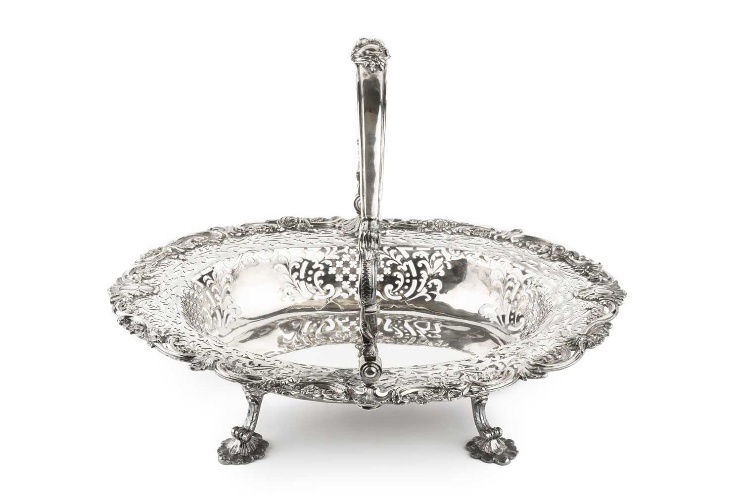 Lot A George II silver oval basket, the shaped...