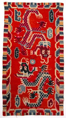 Lot 328 - An antique Tibetan dragon rug with red blue...