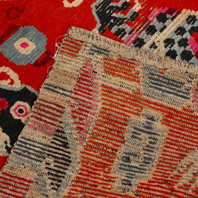 Lot 328 - An antique Tibetan dragon rug with red blue...