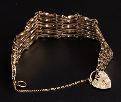 Lot 32 - a 9ct gold gate link bracelet with a padlock clasp