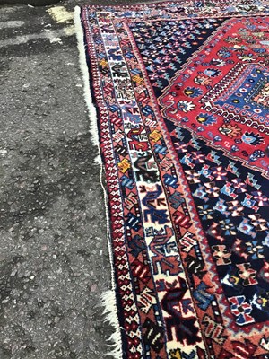 Lot 380 - A modern Isfahan red ground rug with five...