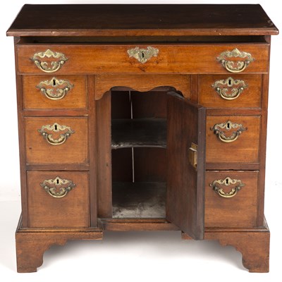 Lot 386 - A George III mahogany kneehole desk with brass...