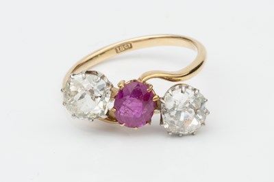Lot 145 - A ruby and diamond three stone ring, the...