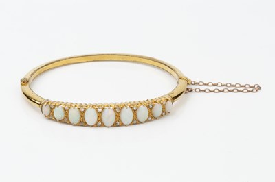Lot 149 - An opal and diamond set hinged bangle, the...