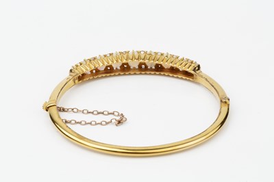 Lot 149 - An opal and diamond set hinged bangle, the...