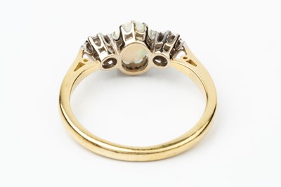 Lot 157 - An opal and diamond three stone ring, the...