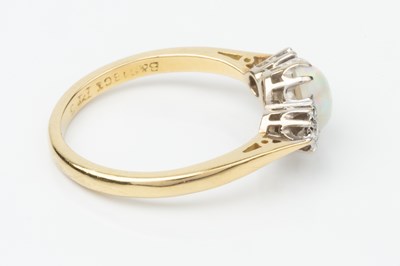 Lot 157 - An opal and diamond three stone ring, the...