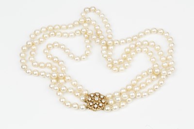 Lot 189 - A triple strand cultured pearl necklace, the...